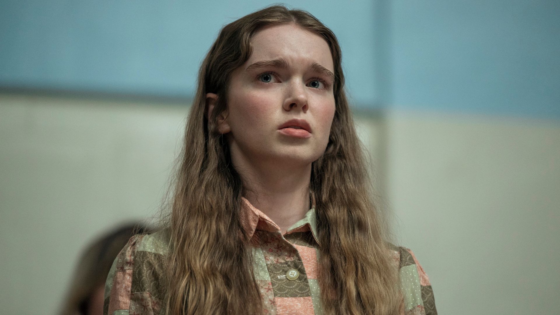 Carrie looks concerned about something offscreen