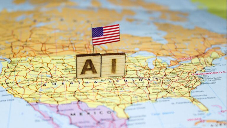 The word “AI” is composed of wooden blocks on a map of the United States with the US flag, reflecting the advancement of artificial intelligence in the American economic and technological landscape