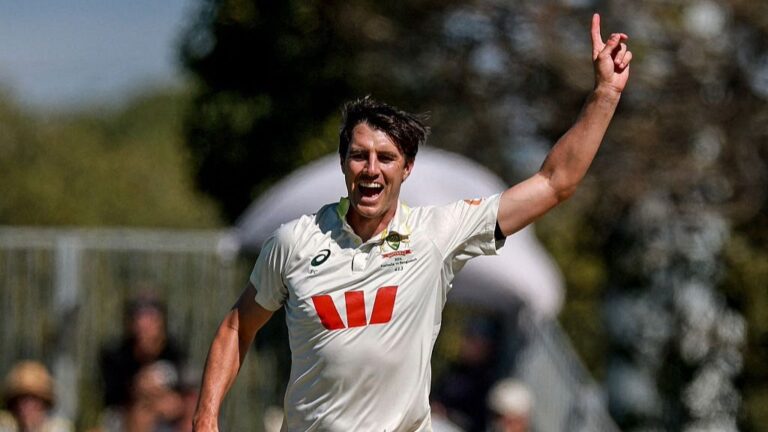 Pat Cummins raises his finger in the air after claiming a Test wicket for Australia.