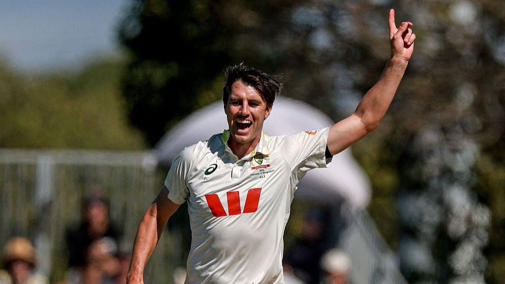 Pat Cummins raises his finger in the air after claiming a Test wicket for Australia.