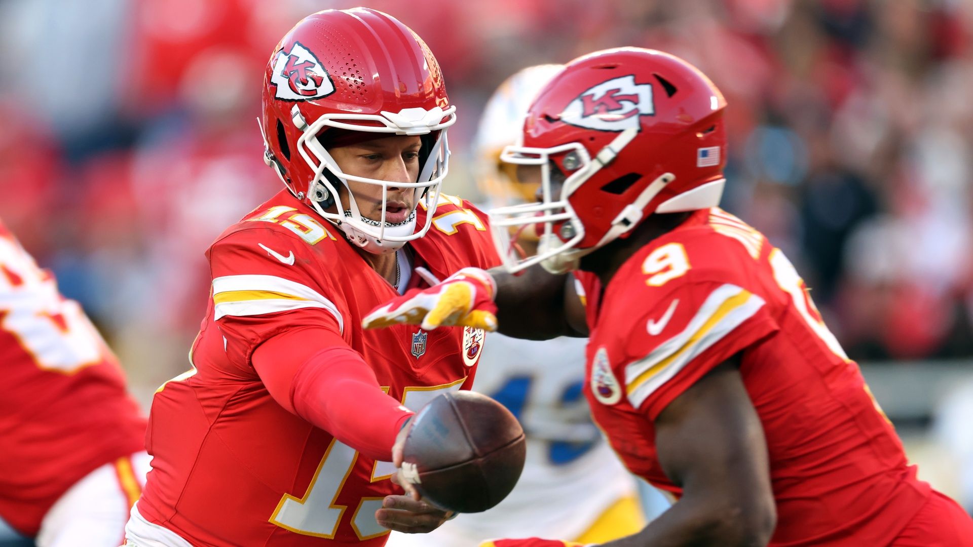 Kansas City Chiefs quarterback Patrick Mahomes handing the ball off to running back Kenneth Walker
